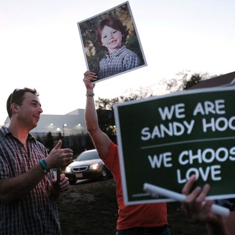 Mark Barden holds up a picture of his son Daniel w
