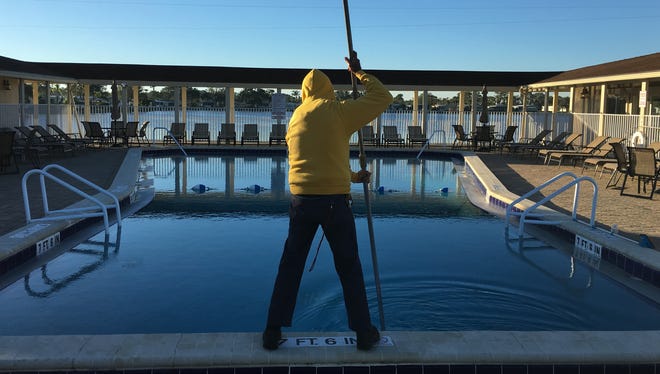 Joe Moramarco of Lamplighter Village in Melbourne does the daily pool cleaning on Dec. 11, 2017. Despite the cold weather -- it was forecast to have a low of 35 degrees -- Joe says there were a few swimmers on Dec. 10.