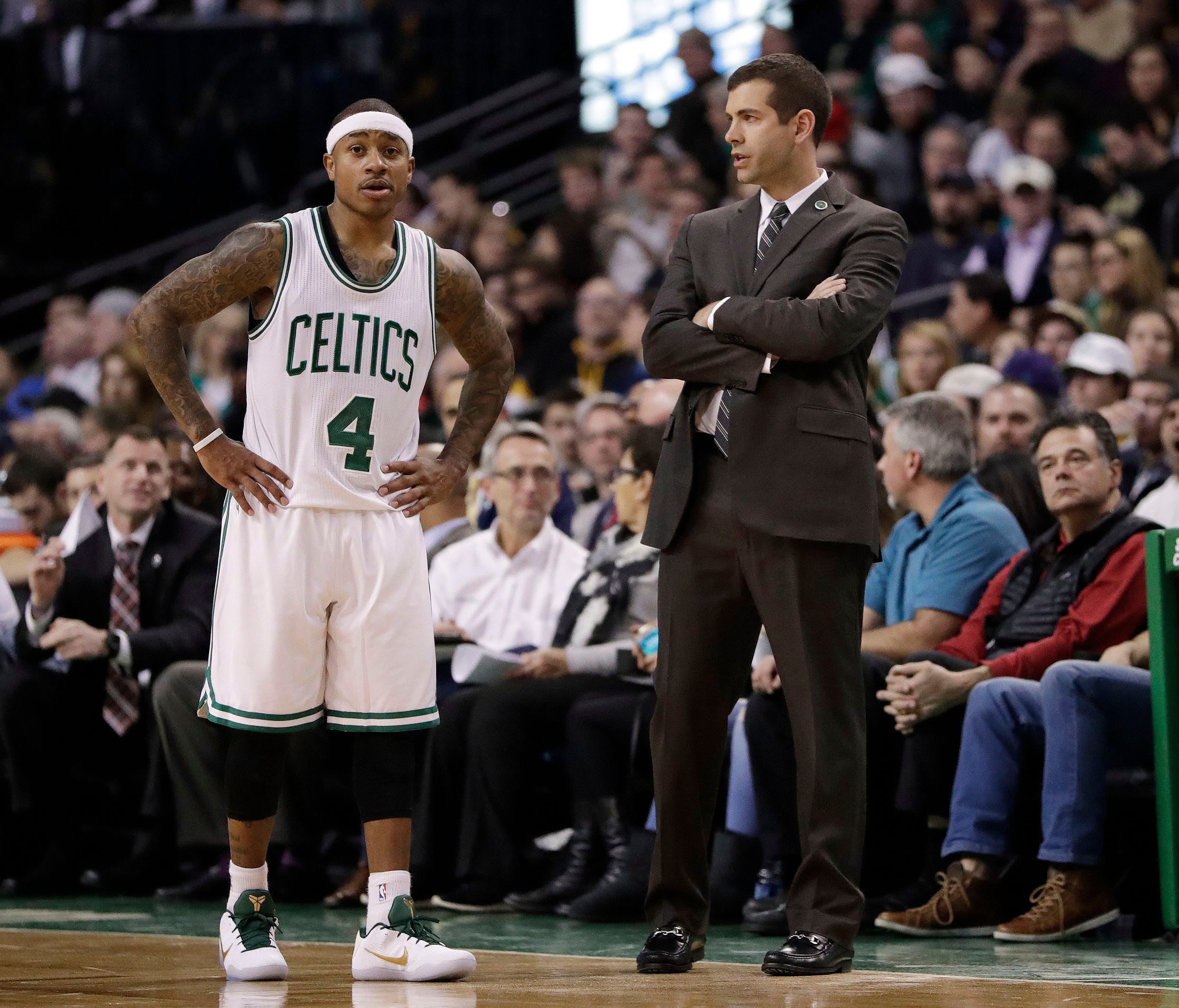Boston Celtics guard Isaiah Thomas talks with head coach Brad Stevens as they take on the Charlotte Hornets in the second half at TD Garden.