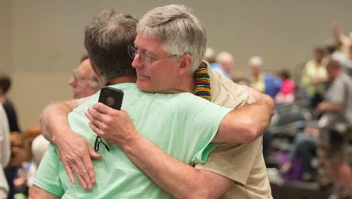 FILE - In this June 19, 2014, file photo, Gary Lyon, left, of Leechburg, Pa., and Bill Samford, of Hawley, Pa., celebrate after a vote allowing Presbyterian pastors discretion in marrying same-sex couples at the 221st General Assembly of the Presbyterian Church at Cobo Hall, in Detroit. The Presbyterian Church (U.S.A.) approved redefining marriage in the church constitution Tuesday, March 17, 2015, to include a "commitment between two people," becoming the largest Protestant group to formally recognize gay marriage as Christian and allow same-sex weddings in every congregation. (AP Photo/Detroit News, David Guralnick, File) 
