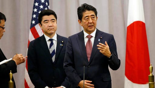 Japanese Prime Minister Shinzo Abe, right, gestures as he answers questions from the media after meeting with U.S. President-elect Donald Trump, Thursday, Nov. 17, 2016, in New York. Abe made a stop in New York to meet with Trump while en route to an APEC meeting in Lima, Peru.