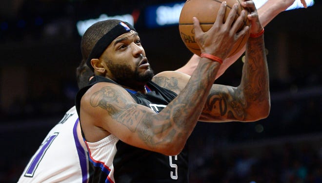 Los Angeles Clippers center Josh Smith grabs a rebound against the Sacramento Kings.