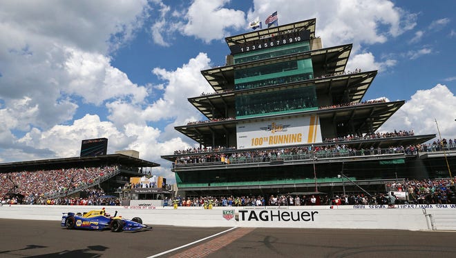 IndyCar driver Alexander Rossi crosses the finish line to win the 100th running of the Indianapolis 500, Indianapolis Motor Speedway, Sunday, May 29, 2016. 