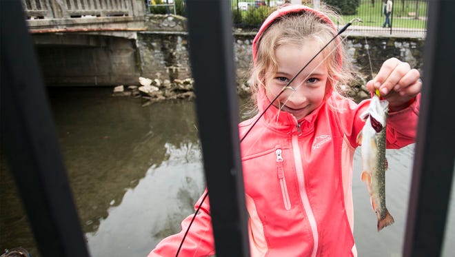 Dallastown's Kayleigh Vedder, 7, shows a brook trout she caught during the William Shaffer Trout Fishing Derby at Kiwanis Lake recently. Introducing children to fishing can produce lifetime memories.