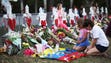People visit a makeshift memorial in front of Marjory