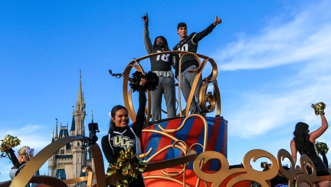Central Florida football players Shaquem Griffin (left) and McKenzie Milton wave to fans during the parade at Disney World in the Magic Kingdom on Sunday.