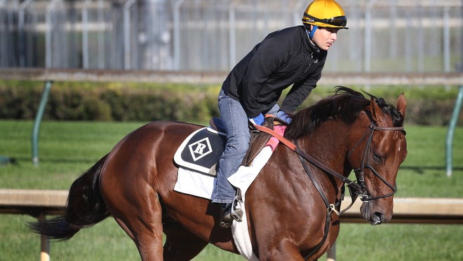 Keen Ice trains on the track at Churchill Downs with exercise rider Faustino Aguilar.October 14, 2015