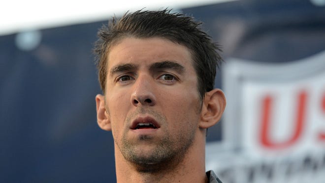 Michael Phelps on the stand for his award after finishing second in the Men's 100Meter Butterfly final at the USA Swimming Nationals at the William Woollett Jr. Aquatics Complex.