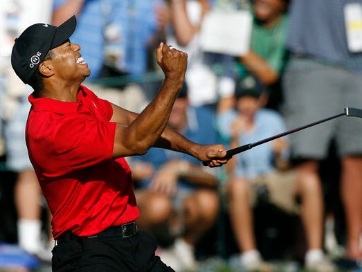 Tiger Woods celebrates after making a birdie on the