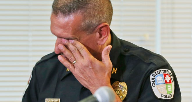 Charlottesville (Va.) Police Chief Tim Longo wipes his eyes as he and Col. Steve Sellers of Albermarle County police brief the media on the discovery of remains Oct. 18, 2014, in Albermarle County, Va., which are believed to be those of missing University of Virginia student Hannah Graham.
