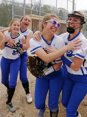 Random Lake softball players celebrate their 6-4 win over Mishicot, Monday, May 14, 2018, in Random Lake, Wis.