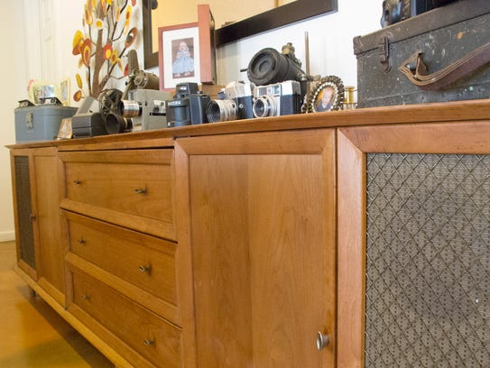 A vintage stereo cabinet in the dining room once belonged