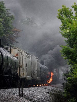 Smoke rises from a CSX train following the derailment of a train car, Thursday, July 2, 2015, in Maryville, Tenn. The derailment of the car, carrying a flammable and toxic substance, caused the evacuation of thousands in the surrounding area. (Michael Patrick/Knoxville News Sentinel via AP)