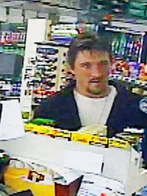 In this April 4, 2017 frame grab from a surveillance video released by the Rock County Sheriff's Office, Joseph Jakubowski makes a purchase at a gas station in Janesville, Wis. The hunt continues Monday, April 10, 2017, for Jakubowski, who is suspected of stealing firearms from a Wisconsin gun store and sending an anti-government manifesto to President Donald Trump.