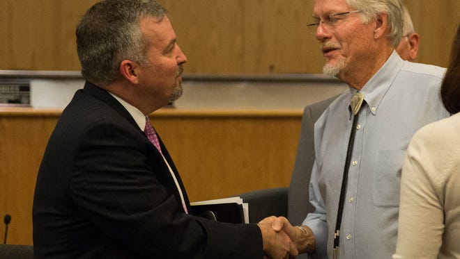 Chuck Mahon shakes hands with County Commissioner Billy Garrett of district one after Mahone was named the new interim county manager by the Doña Ana County Commissioners, Wednesday, May 2, 2017.
