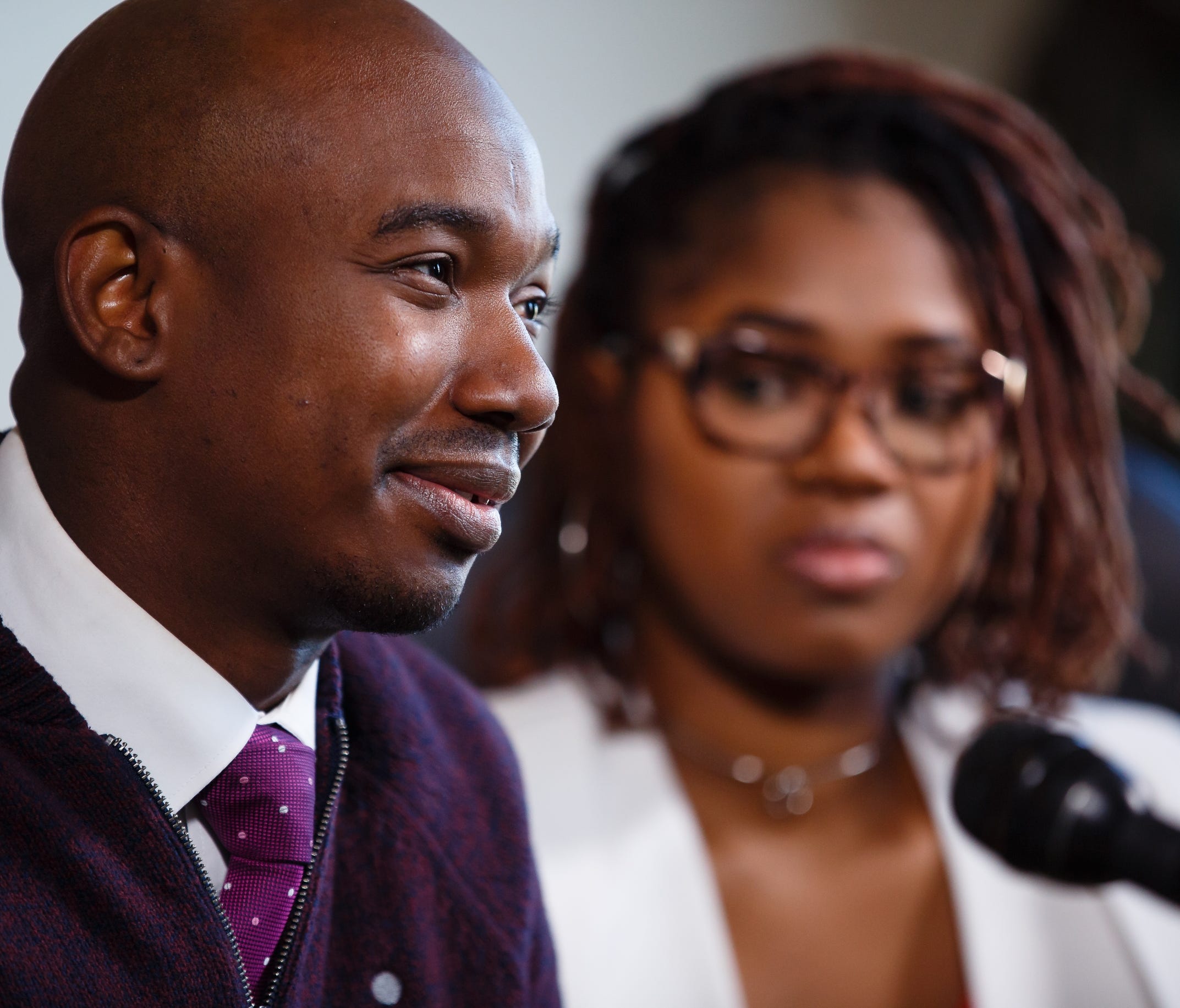 James Conley III, center, whose Facebook post of a racial profiling incident at the Old Navy store in West Des Moines went viral, speaks to the media with his wife to his left and Betty C. Andrews, President, Iowa-Nebraska NAACP State Area Conference