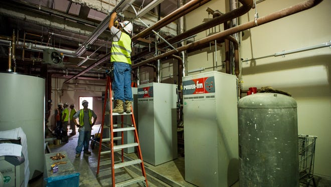 Construction workers continue progress in a boiler room at the site of the new UL Student Union in Lafayette, LA, Monday, July 14, 2014.    Photo by Paul Kieu, The Advertiser