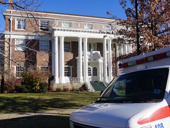 An ambulance sits outside the Chi Psi house in Boulder,