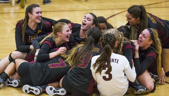 The Salpointe Catholic High School girls volleyball team erupts in cheers as they defeat Greenway High School for the 4 A State Championship, 3-1, at Mountain Pointe High School, Wednesday, November 9, 2016.