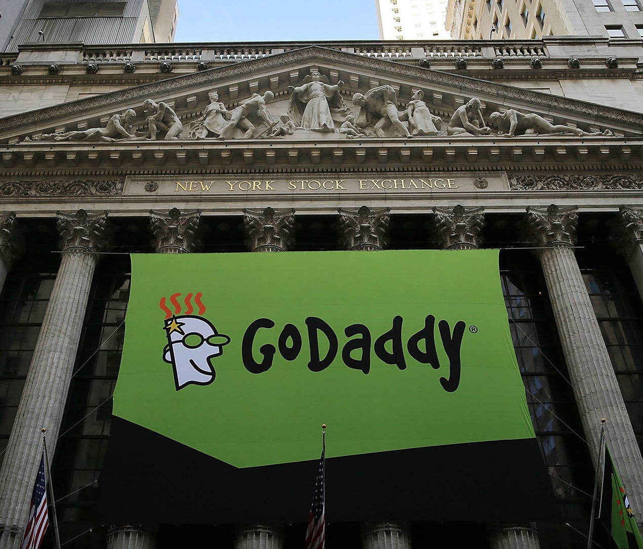The GoDaddy banner hangs outside of the New York Stock Exchange as the website hosting service makes its initial public offering April 1, 2015, in New York City. On Sunday, Aug. 13, 2017, the company announced it would no longer provide service to th