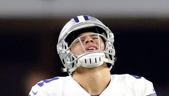Dallas Cowboys quarterback Dak Prescott (4) reacts during the fourth quarter against the Green Bay Packers in the NFC Divisional playoff game at AT&T Stadium.