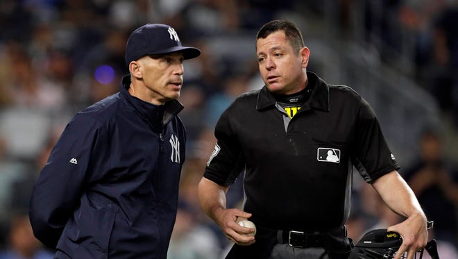 Yankees manager Joe Girardi talks with home plate umpire Carlos Torres (37) during the fifth inning of the Tigers' 4-0 loss Friday at Yankee Stadium.