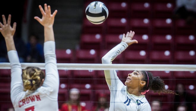 Cathedral's Nia Robinson hits past the Crown Point's defense during their state final match at Worthen Arena Saturday.