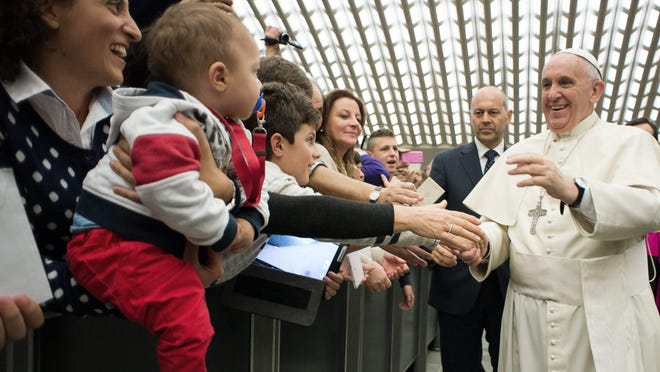 
Pope Francis greets people during his audience with members of the Italian Catholic Doctors' Association, Paul VI Hall. 
