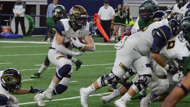 Stephenville's Krece Nowak crashes into the line for a 2-yard TD in the first half of Stephenville's playoff loss t  Kennedale in a Class 4A DI state semifinal at AT&T Stadium in 2017.