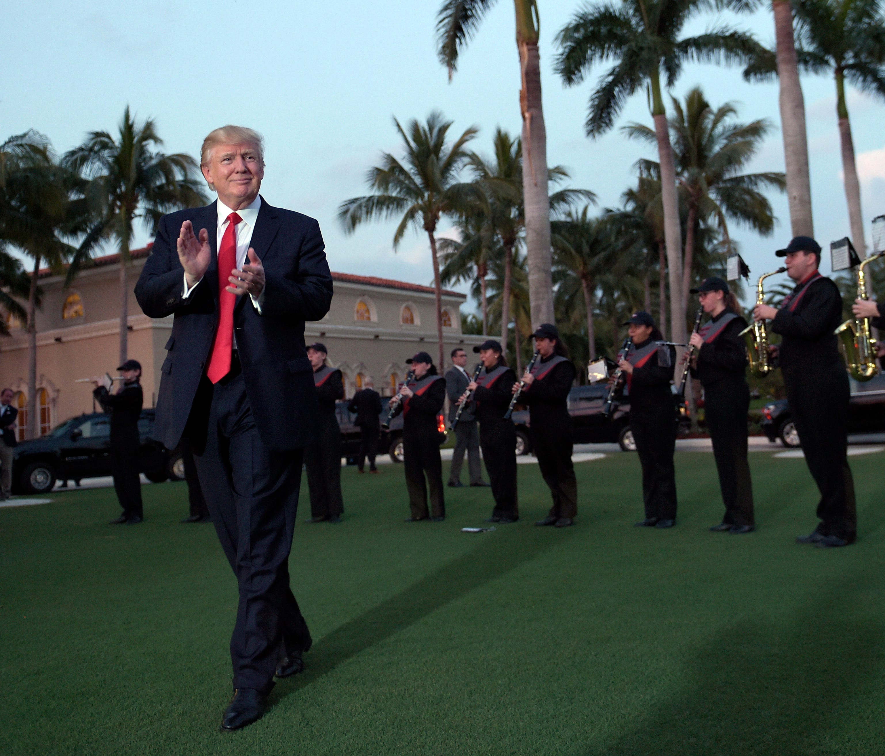 President Trump listens to the Palm Beach Central High School Band as they play at his arrival at Trump International Golf Club in West Palm Beach, Fla., on Feb. 5, 2017. The Trumps will be watching the Super Bowl.   Trump visited Trump International 