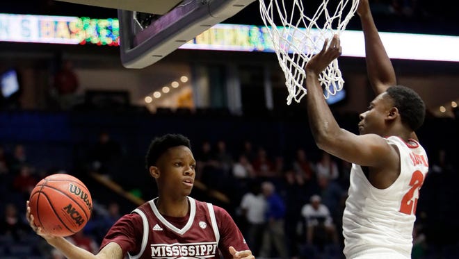 Mississippi State guard Tyson Carter (23) passes around Alabama guard Brandon Austin, right, during the second half of an NCAA college basketball game at the Southeastern Conference tournament Thursday, March 9, 2017, in Nashville, Tenn. Alabama won 75-55.