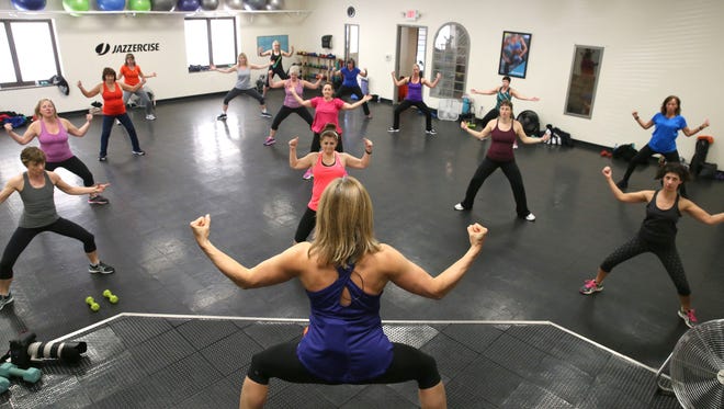 Instructor Sue Grassi of Webster leads her packed class through a series of moves during their interval fusion Jazzercise class Monday, March 21, 2016 at the Jazzercise Webster Fitness Center on Ridge Road in Webster.