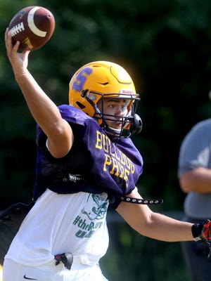 Smyrna's Blake Watkins (21) tosses a pass out of the Wildcat set during a practice this week.