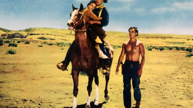 Natalie Wood, from left, John Wayne and Jeffrey Hunter appear in a scene from the 1956 John Ford western, “The Searchers.”