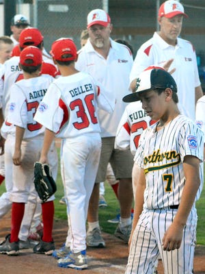 Kaisen Valenzuela (7) walks back to the dugout in tears after the Shorthorn 11 year olds lost 5-4 against Albuquerque-Roadrunner in Saturday's state tournament semifinals.