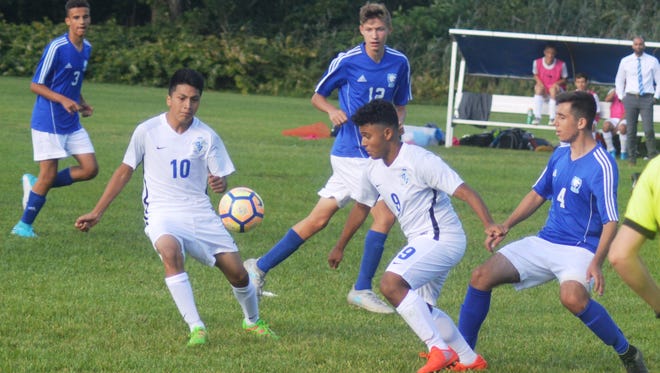 Wood-Ridge sophomore midfielders Erick Zapata (9) and Andy Quituizaca (10) battling for the ball against Wallington.