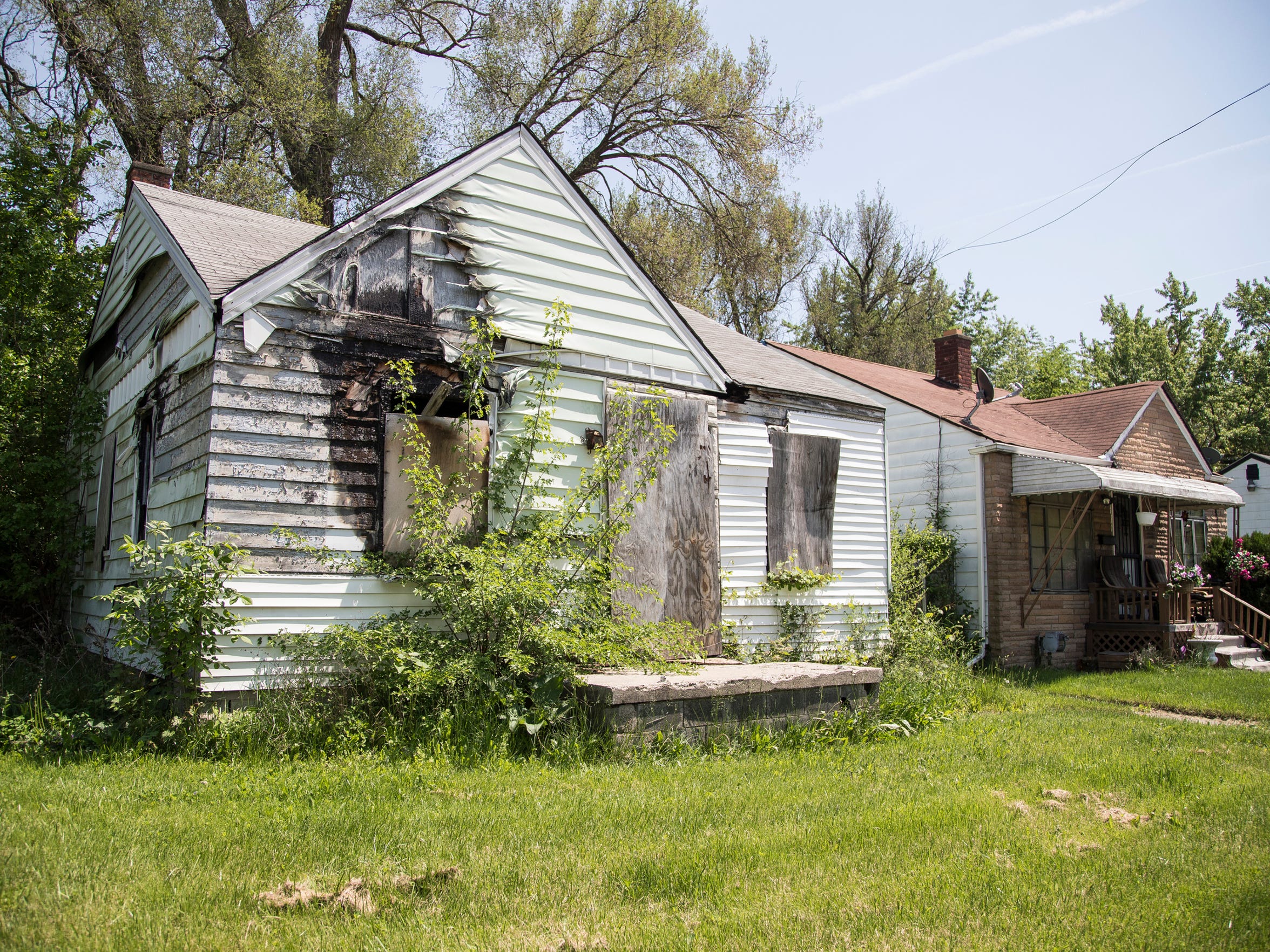 A burned house next to LaVerta Washington's place on Alpine Street in Detroit. (Photo taken May 25, 2018)