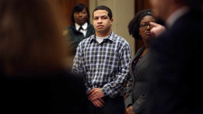Eric Rivera, Jr. stands as the jury enters the courtroom for closing arguments at Rivera's trial Wednesday. Rivera is accused of fatally shooting Washington Redskins star Sean Taylor during a failed 2007 burglary.