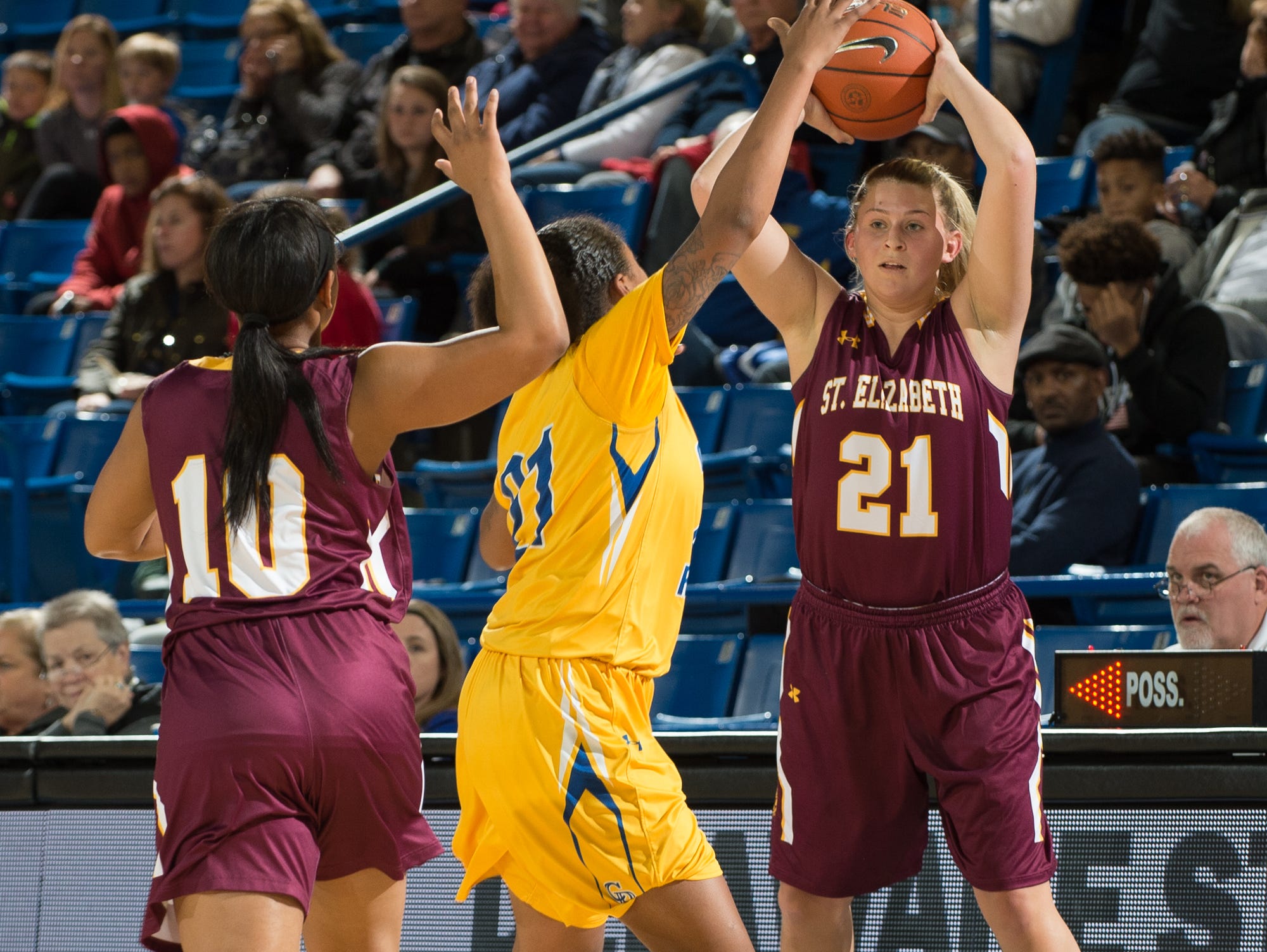 St. Elizabeth’s Sarah Metz (21) looks for a pass to teammate Sha’Nia Davis (10) in the quarterfinals of DIAA Girls Basketball Tournament at the University of Delaware against Caesar Rodney.