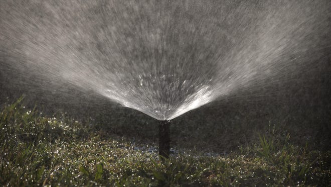 A sprinkler waters the lawn of a home on Wednesday, May 18, 2016, in Santa Ana, Calif. (AP Photo/Jae C. Hong)