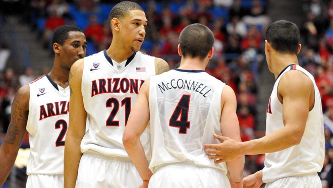 Arizona Wildcats forward Rondae Hollis-Jefferson (23) forward Brandon Ashley (21) guard T.J. McConnell (4) and guard Nick Johnson (13) huddle up during the second half against the Colorado Buffaloes at McKale Center.