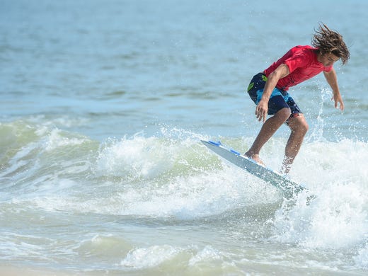 Mason Broussard, Gulf Shores, AL, catches a wave during