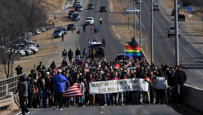 Marchers celebrate the life of civil rights icon Martin Luther King, Jr. during the annual march Monday Jan. 15, 2018 over the bridge bearing his name east of downtown Abilene. At least 200 adults, children and others of diverse backgrounds and color crossed the bridge going west, then turned and crossed again to return to their starting point at the corner of E. Highway 80 and Cockerell Dr.