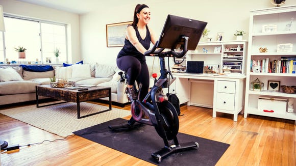Getting a Peloton indoor bike is like installing a spinning studio in your living room.