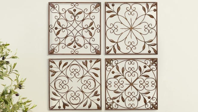 These wall decorations have a floral scrollwork motif.