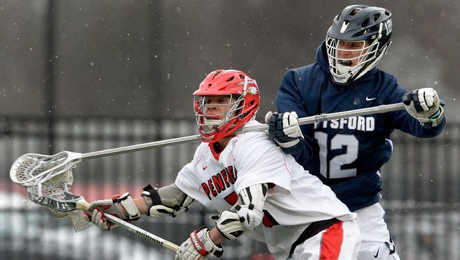 Penfield’s Joey Barboza, left, is defended by Pittsford’s Trevar Hall during a regular season game played at Penfield High School, Thursday, April 19, 2018.