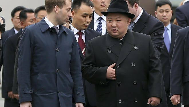 In this photo released by the press office of the administration of Primorsky Krai region, North Korea's leader Kim Jong Un, right, surrounded by Russian and North Korea's officials arrive in Vladivostok, Russia, Wednesday, April 24, 2019.