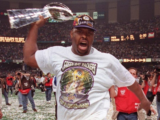 Reggie White parades around the Superdome with the Lombardi Trophy.