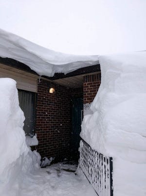 The backside of Tealwood Apartments in Marshfield are completely covered in snow drifts.