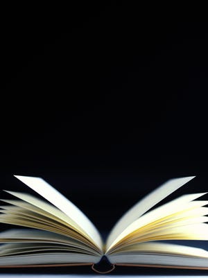 close-up of an open book with pages flying